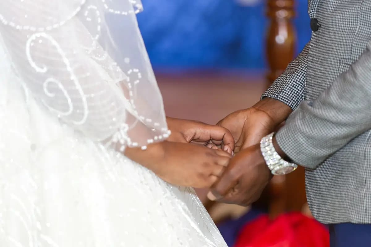 The bride and groom's hands, one in the other, during the ceremony